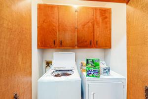 a small laundry room with a washer and dryer at 2-Story Home with Covered Patio, Balcony, Fireplace, Streaming, Great Views, W/D in Kerrville +21 photos