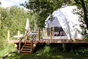 a tent on a wooden deck in a field at Woodland Creek in Chase