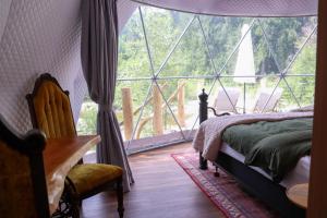 a bedroom with a bed and a large window at Woodland Creek in Chase