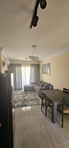 a living room with a couch and a table at Rahaf palm beach chalet in Ain Sokhna