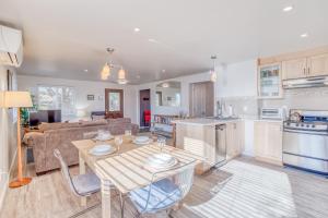 a kitchen and living room with a table and a couch at Sandy Feet in Nehalem