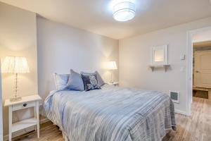 a bedroom with a bed and a table with a lamp at Sandy Feet in Nehalem