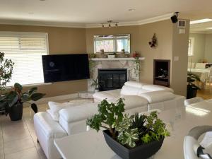a living room with white couches and a fireplace at View of Ocean & MOUNT BAKER in White Rock