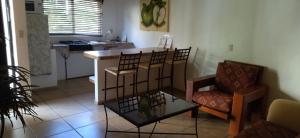 a living room with a couch and a chair and a table at HOTEL PARAISO ESCONDIDO in Chacala