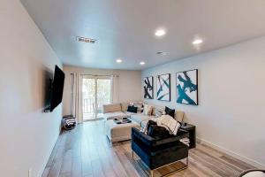 a living room with a couch and a tv at Contemporary, Dog-Friendly Townhouse with Balcony, Pool & Day Docks in Horseshoe Bay