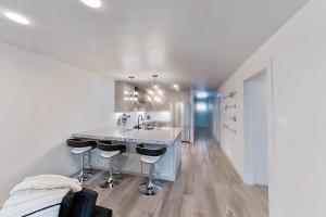 a white kitchen with a sink and a counter at Contemporary, Dog-Friendly Townhouse with Balcony, Pool & Day Docks in Horseshoe Bay +14 photos