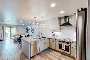 a kitchen with a sink and a stove at Contemporary, Dog-Friendly Townhouse with Balcony, Pool & Day Docks in Horseshoe Bay