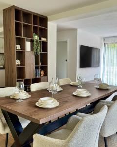 a dining room with a wooden table and chairs at RiverHouse Tošinović in Šipovo +7 photos