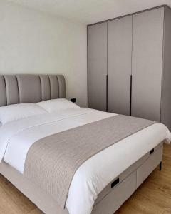a bedroom with a large white bed and cabinets at RiverHouse Tošinović in Šipovo