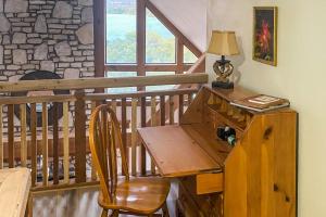 a desk with a lamp on a wooden table on a balcony at Lovely 2-Story Home with Upper & Lower Decks, Gorgeous Lake & Hill Country Views in Burnet