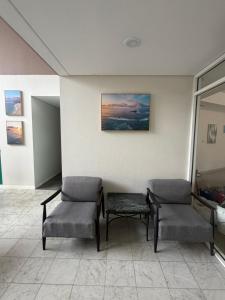 a waiting room with two chairs and a table at Seaside Garden Hotel in Wamberal +24 photos