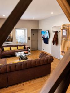 a living room with a couch and a table at Suite Le Mans 70 in Pusey