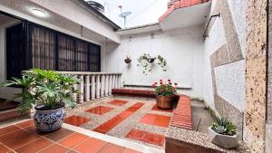 a balcony of a house with potted plants at Urban House in Florencia
