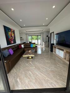 a living room with a couch and a table at AVANA Villa in Nathon Bay