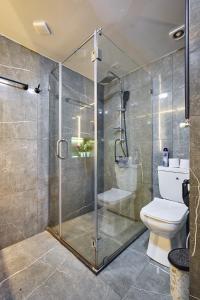a bathroom with a glass shower with a toilet at 4Season Villa in Tbilisi City +34 photos