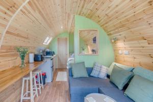 a living room with a blue couch and a kitchen at 1 Bed in Blairdrummond oc-b37875 in Doune