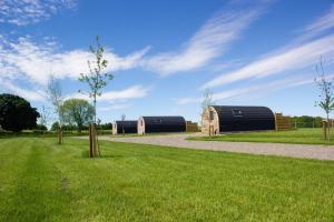 a field with two barns and a dirt road at 1 Bed in Blairdrummond oc-b37875 in Doune