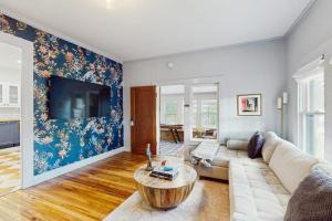 a living room with a couch and a table at Blue Haus with Hot Tub, Shuffleboard, EV Charger - Walk to Town & Wineries in Johnson City