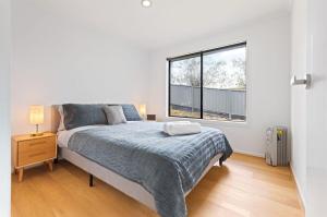 a bedroom with a large bed and a window at Marlin Vista - Pet Friendly in Eden