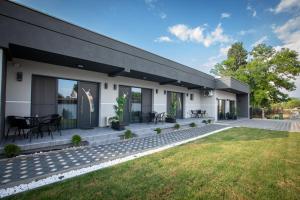 a house with a patio and a lawn at Sofia Luxury Apartments in Gevgelija