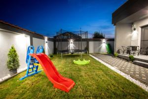 a backyard with a slide and a playground at Sofia Luxury Apartments in Gevgelija