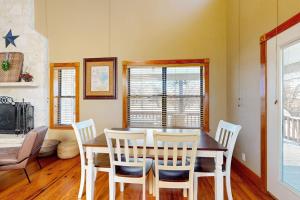 a dining room with a table and chairs at Peaceful Home with Fire Pit, Gazebo, Patio, & Amazing Deck Views - Dog-Friendly in Fredericksburg