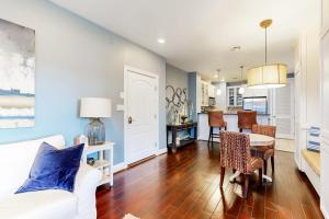 a living room with a white couch and a table at Water-View Condo with Balcony, Smart TVs, Washer/Dryer and Pool in Horseshoe Bay