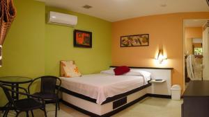 a bedroom with a bed and a table and chairs at Casa D'mer Taganga in Taganga