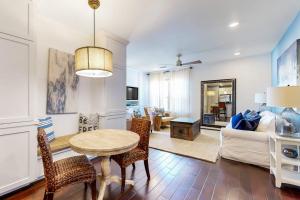 a living room with a table and chairs and a couch at Water-View Condo with Balcony, Smart TVs, Washer/Dryer and Pool in Horseshoe Bay