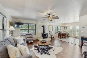 a living room with a couch and a fireplace at Idyllic Home with Firepit, Gazebo, Patio, & Amazing Deck Views - Dog-Friendly in Fredericksburg