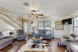 a living room with a couch and a ceiling fan at Idyllic Home with Firepit, Gazebo, Patio, & Amazing Deck Views - Dog-Friendly in Fredericksburg