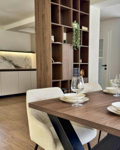 a dining room with a wooden table and chairs at RiverHouse Tošinović in Šipovo