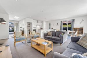 a living room with a couch and chairs and a table at Archway Motels & Chalets in Wanaka