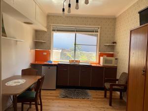 a small kitchen with a table and a window at 1 Bedroom Flat with Private Kitchen & Ensuite in Bulli