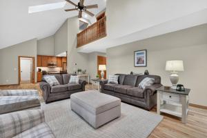 a living room with two couches and a table at Cottage on the Hill in Ephraim