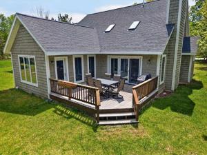 a deck with a table and chairs on a house at Cottage on the Hill in Ephraim