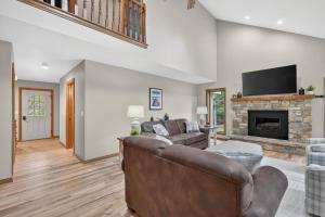 a living room with a couch and a fireplace at Cottage on the Hill in Ephraim