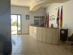 a restaurant with a counter in a room with flags at Appart hôtel Cabo dream in Cabo Negro