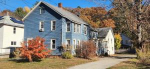 a blue house and a white house and trees at Blooming Inn Shelburne Falls in Shelburne Falls