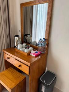 a wooden dresser with a mirror in a room at Swariguna homestay in Sidemen