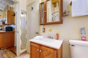 a bathroom with a sink and a toilet at Cozy Dog-Friendly House Near Water with Enclosed Yard, Grill, & Equipped Kitchen in Burnet +9 photos