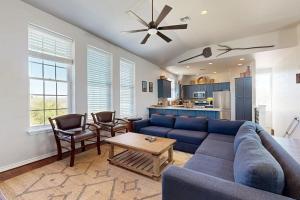a living room with a blue couch and a table at 4-Bedroom Spacious Home with Guest House & Pool, Located on 9 Acres of Land in Spicewood