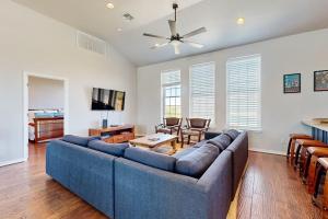 a living room with a blue couch and a table at 4-Bedroom Spacious Home with Guest House & Pool, Located on 9 Acres of Land in Spicewood