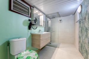 a bathroom with a toilet and a sink and a shower at Fare Aute Beach in Vaianae +94 photos