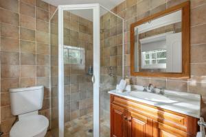 a bathroom with a toilet and a sink and a mirror at Alcheringa Cottage Amazing Location with views in Kangaroo Valley +16 photos