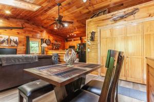 a dining room with a table and a couch at Edge View Chalet in Bryson City