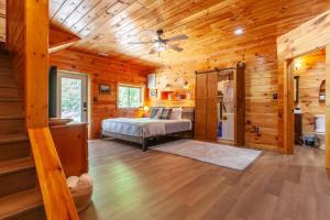 a bedroom with a bed in a wooden cabin at Edge View Chalet in Bryson City