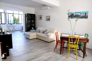 a living room with a table and a couch at Elpidios Galatro Terme in Galatro