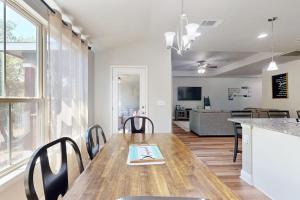 a dining room with a wooden table and chairs at Cozy Lago Vista Home with Private Pool Table, Mile From The Stunning Lake Travis in Lago Vista