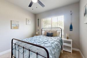 a bedroom with a bed and a ceiling fan at Cozy Lago Vista Home with Private Pool Table, Mile From The Stunning Lake Travis in Lago Vista